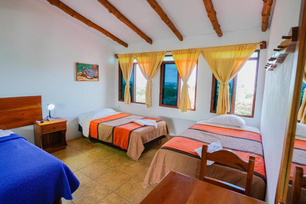 Postel nebo postele na pokoji v ubytování Galapagos Verde Azul