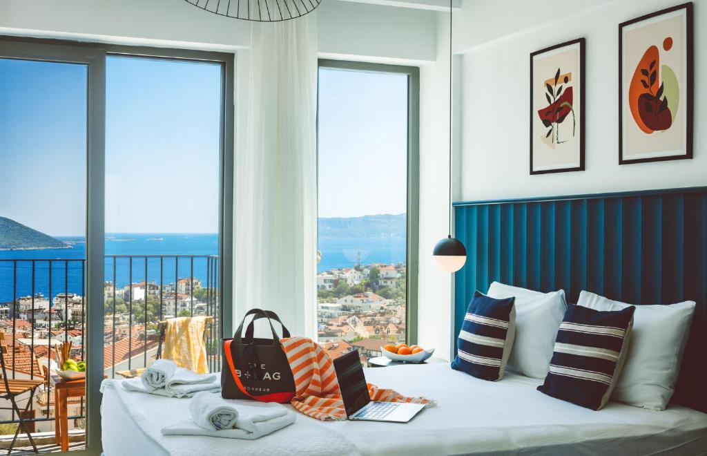 a bedroom with a bed with a view of the ocean at Aphrodite Hotel Kaş in Kas