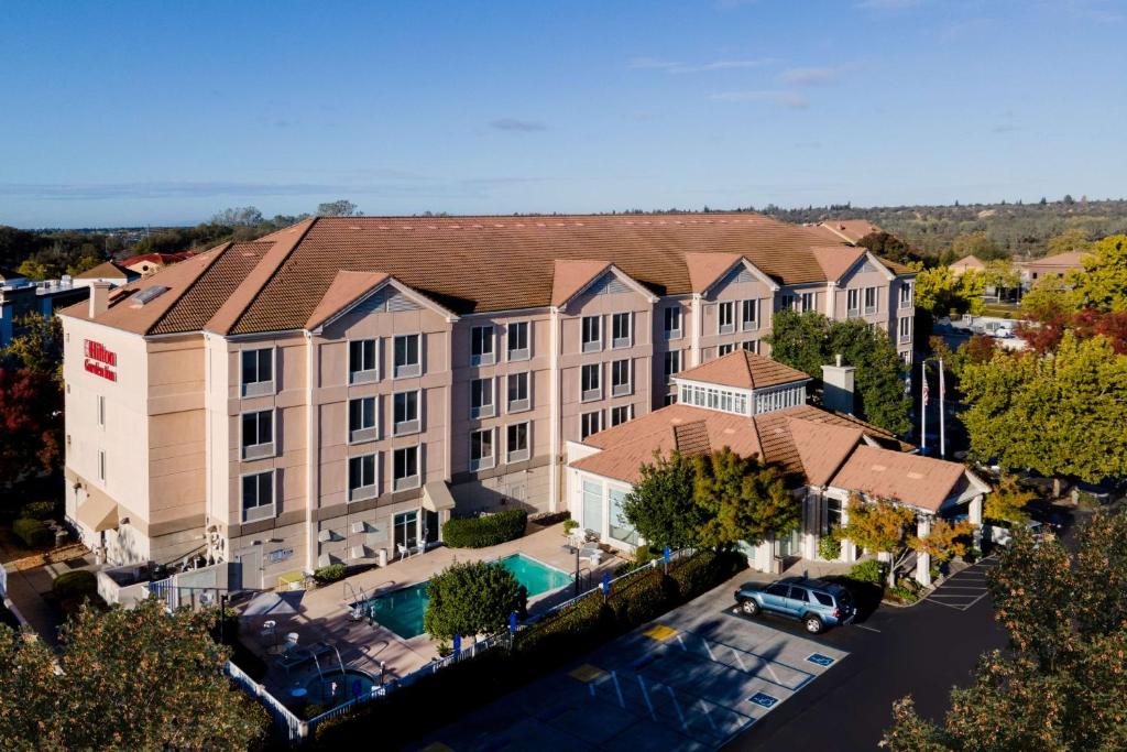 an overhead view of a building with a pool at Hilton Garden Inn Folsom in Folsom