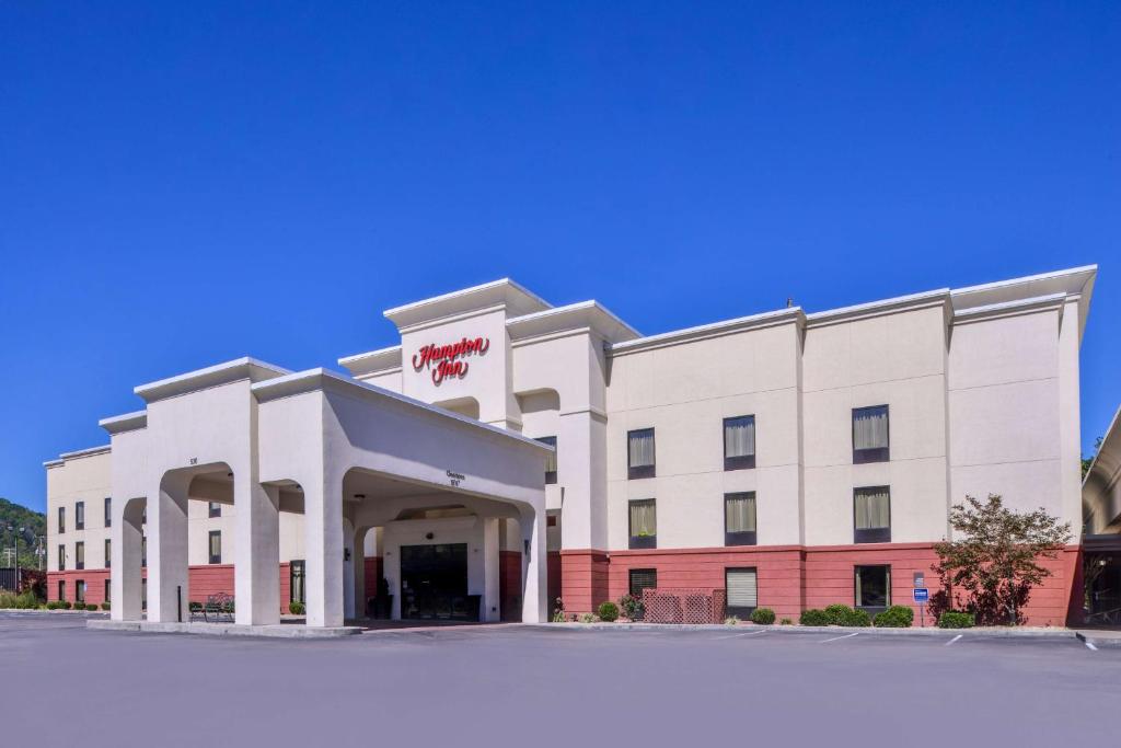 a large white building with a sign on it at Hampton Inn Williamsburg in Williamsburg