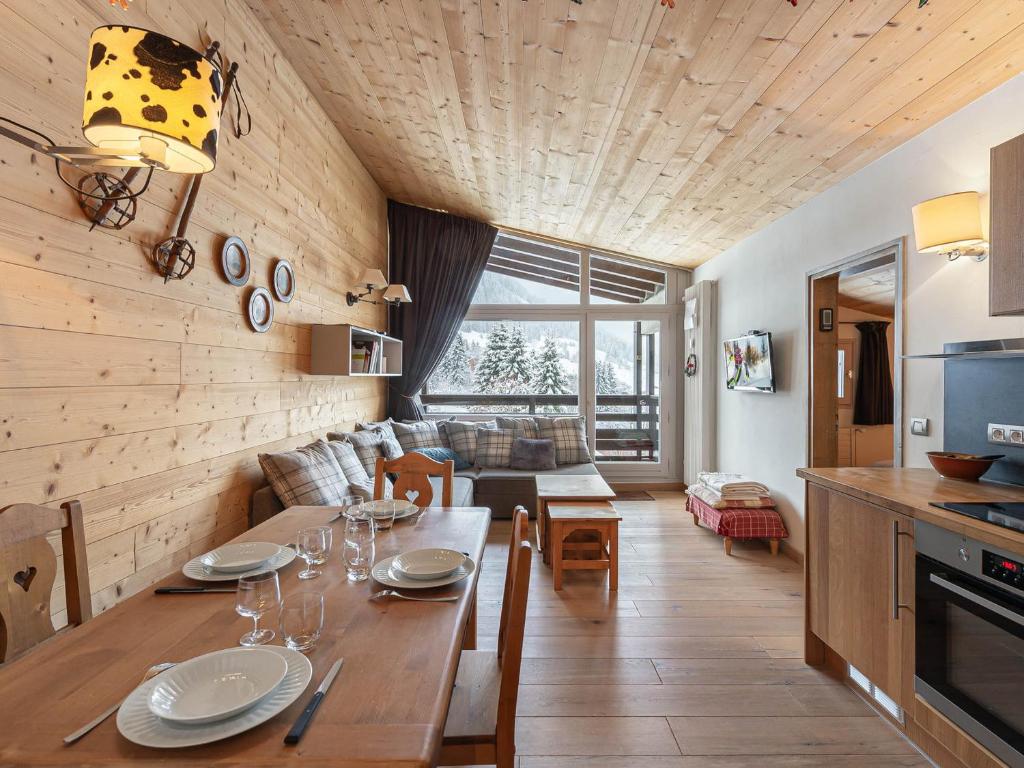 a kitchen and living room with a table and a couch at Appartement Megève, 3 pièces, 4 personnes - FR-1-569-63 in Megève