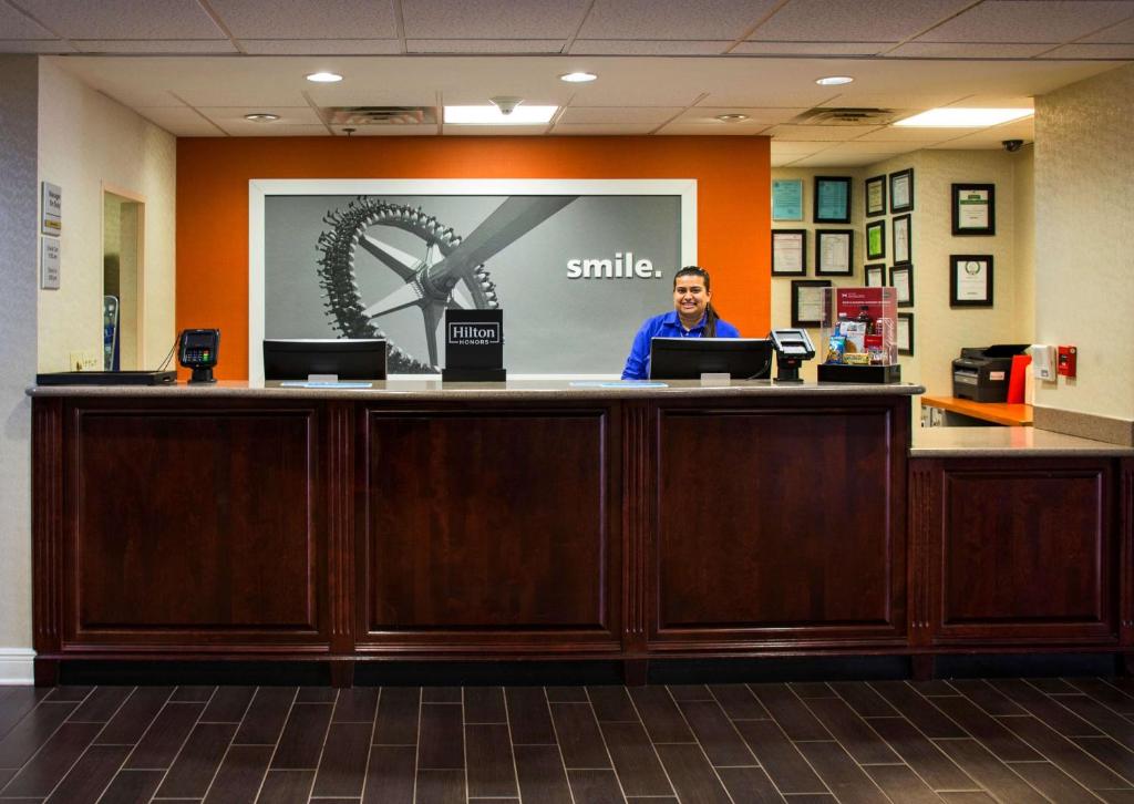 a man sitting at a counter in a waiting room at Hampton Inn & Suites Valdosta/Conference Center in Valdosta