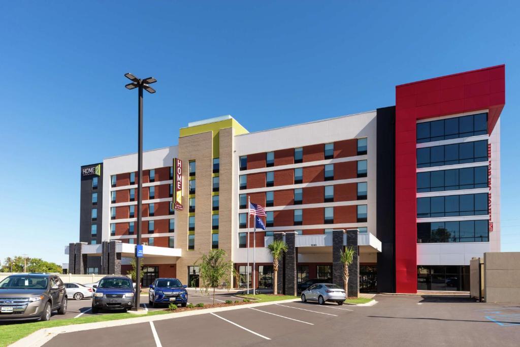 a building with cars parked in a parking lot at Home2 Suites by Hilton Columbia Downtown in Columbia