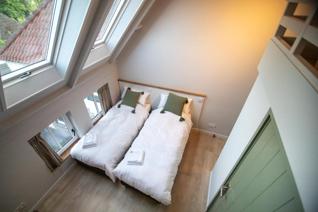 Postel nebo postele na pokoji v ubytování B&B de oude melkfabriek