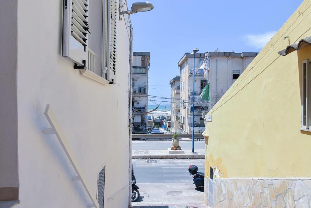 an alley between two buildings with a fire hydrant at essegiHome in Porto Empedocle