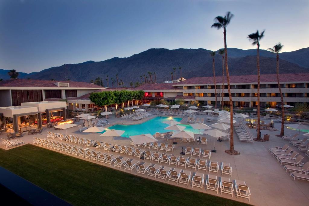 an aerial view of a resort with a pool and chairs at Hilton Palm Springs in Palm Springs