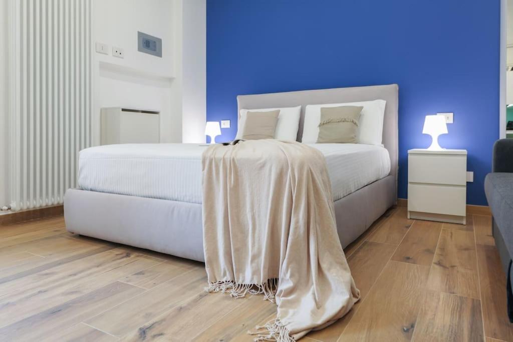 a bedroom with a white bed with a blanket on it at Contempora Apartments - bilocale Washington 105 in Milan