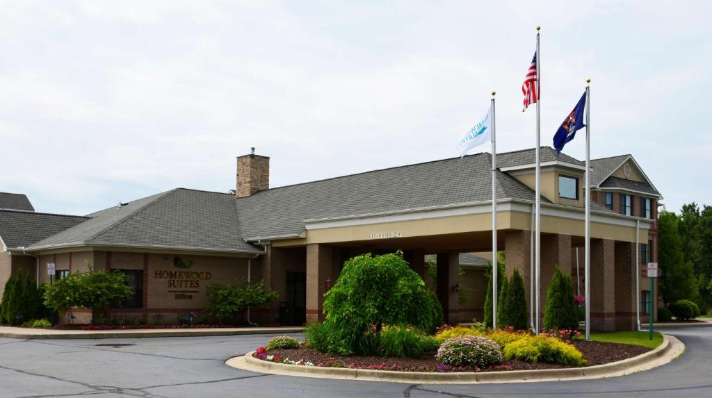 a hotel with flags in front of a building at Homewood Suites by Hilton Brighton in Brighton