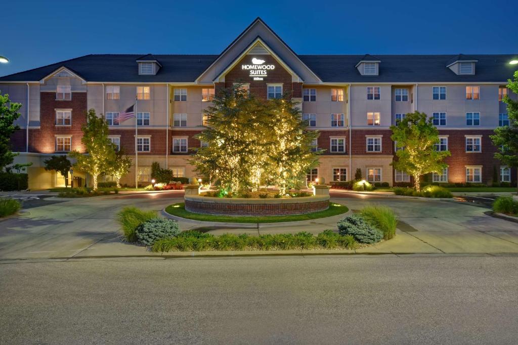 an exterior view of a hotel at night at Homewood Suites by Hilton at The Waterfront in Wichita