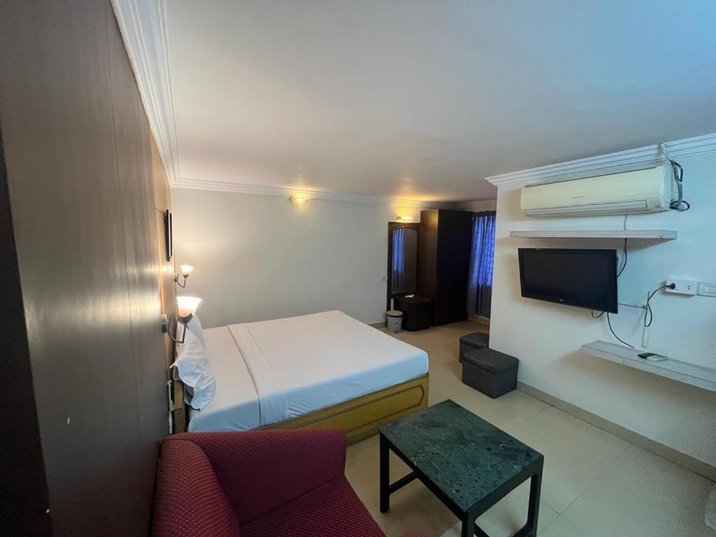 a hotel room with a bed and a tv at Hotel City Tower, Chennai Central in Chennai