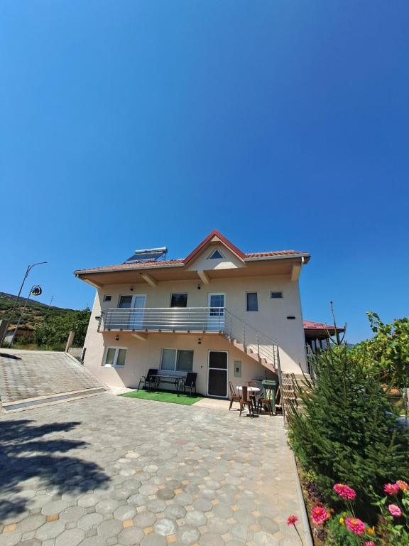 a large house with a balcony and a patio at Lazarov Apartments in Nov Dojran