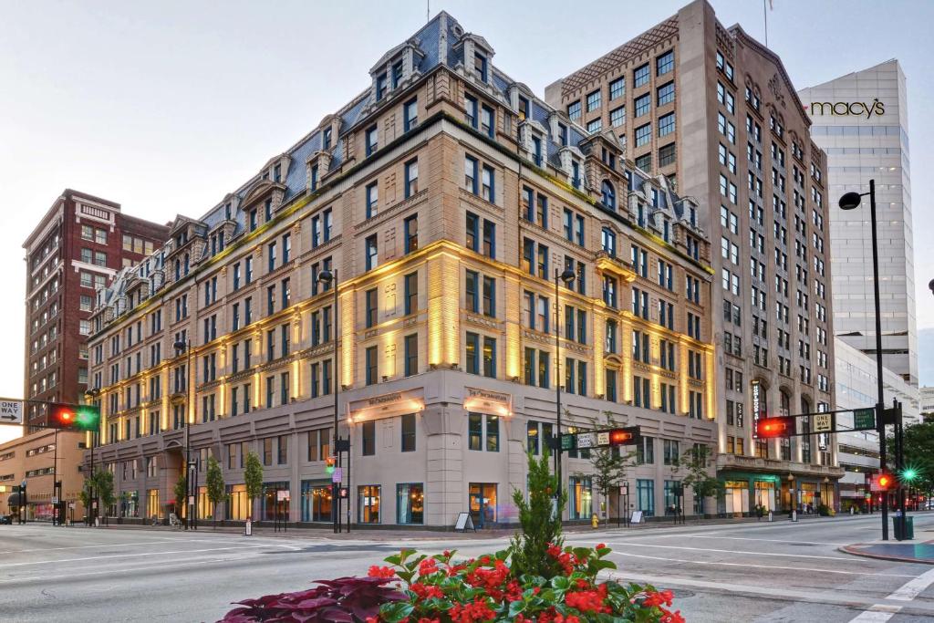 a large yellow building on a city street at The Cincinnatian Curio Collection by Hilton in Cincinnati