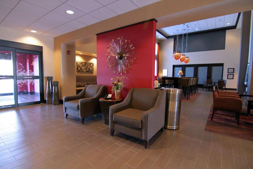a waiting room with chairs and tables in a hospital at Hampton Inn & Suites Grand Forks in Grand Forks