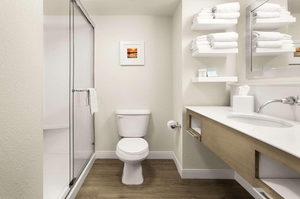 a white bathroom with a toilet and a sink at Hampton Inn Georgetown-Marina in Georgetown