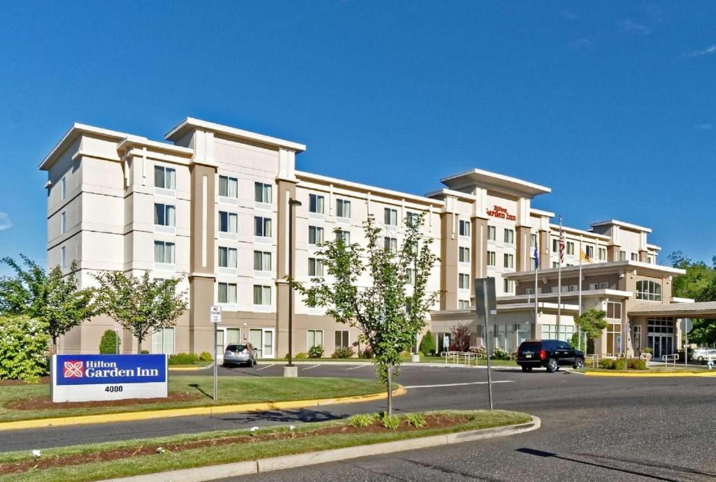 a large white building with a sign in front of it at Hilton Garden Inn by Hilton Mount Laurel in Mount Laurel