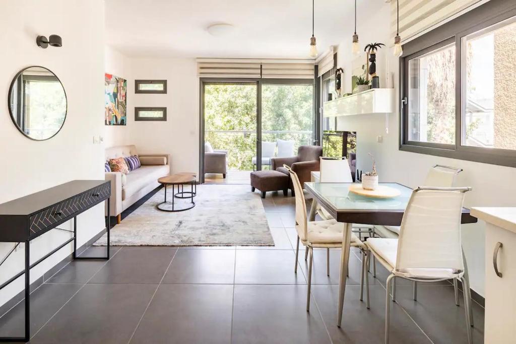 a kitchen and living room with a table and chairs at Luxury Oasis Tel Aviv Beach in Tel Aviv
