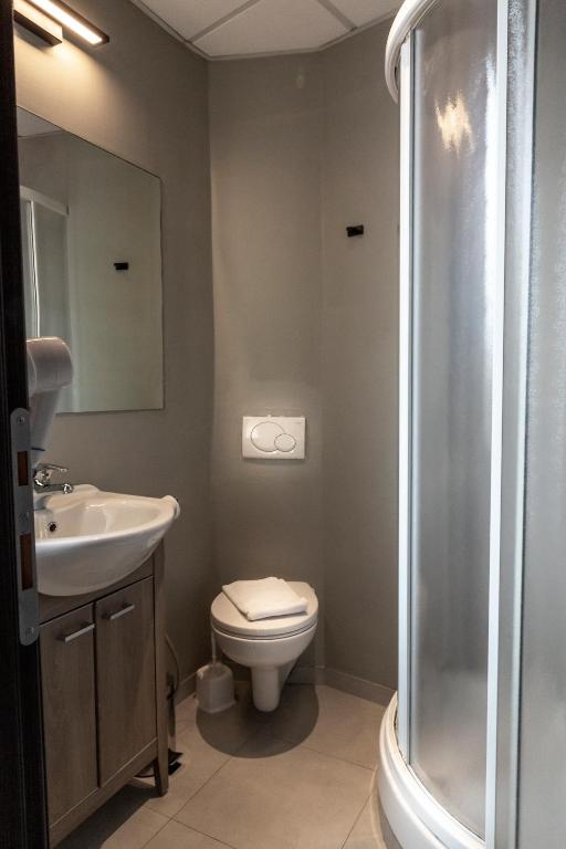 a bathroom with a toilet and a sink and a shower at Plus Florence in Florence