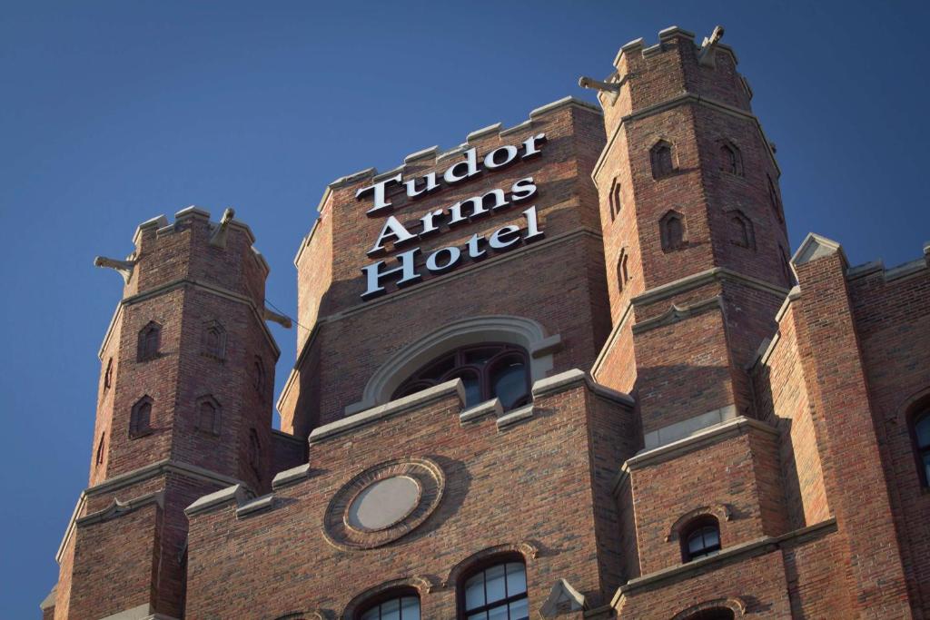 a brick building with two towers on top of it at The Tudor Arms Hotel Cleveland - a DoubleTree by Hilton in Cleveland