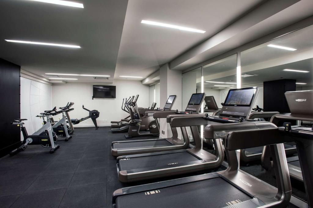 a gym with rows of treadmills and elliptical machines at LondonHouse Chicago, Curio Collection by Hilton in Chicago