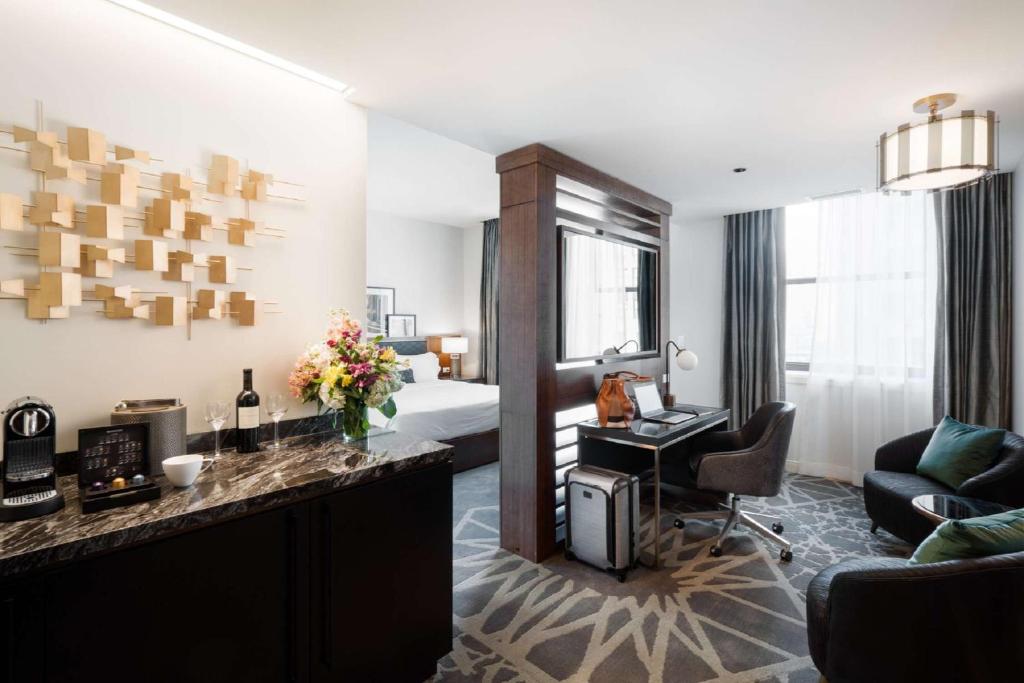 a hotel room with a bed and a desk at LondonHouse Chicago, Curio Collection by Hilton in Chicago