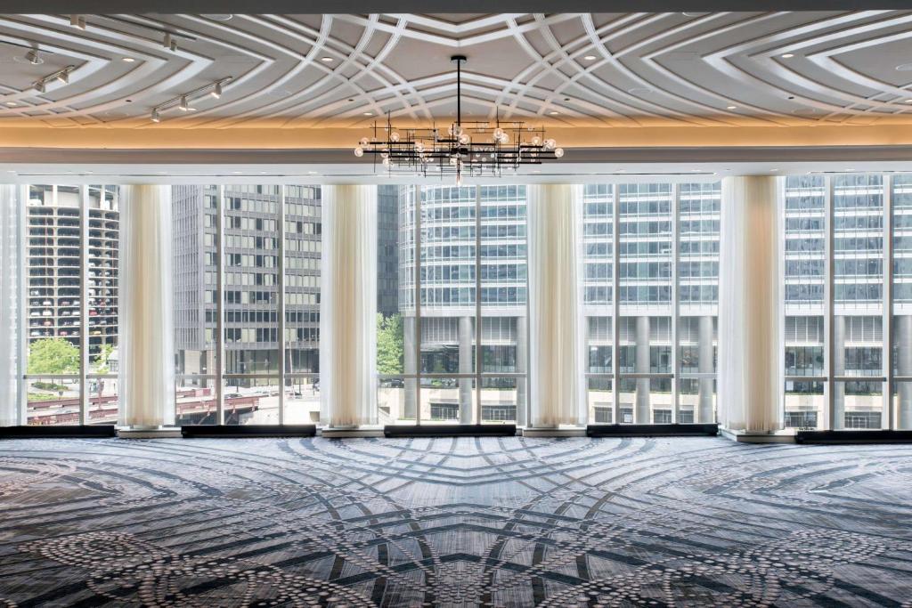 a large room with large windows in a building at LondonHouse Chicago, Curio Collection by Hilton in Chicago