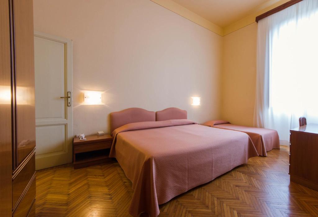 Postel nebo postele na pokoji v ubytování Hotel Reale