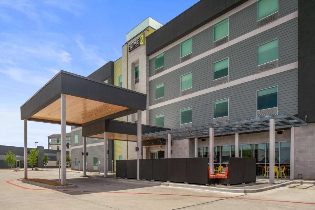 a large building with a canopy in front of it at Home2 Suites By Hilton Rowlett Rockwall Marina in Rowlett