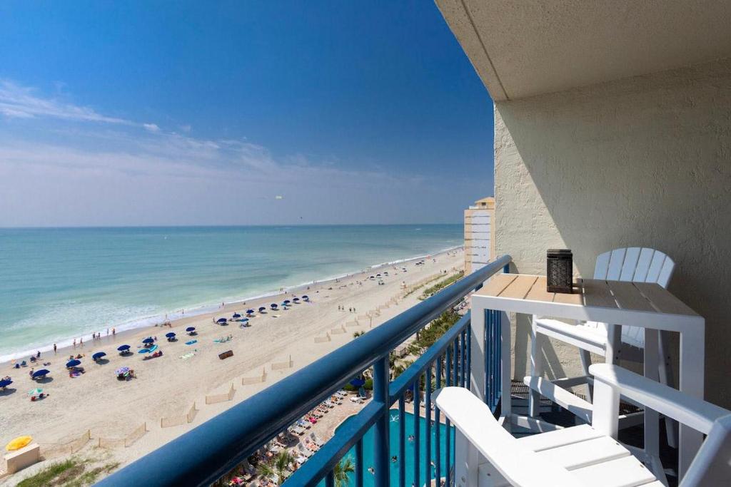 a balcony with a view of a beach and the ocean at Oceanfront Condo with Amazing Oceanfront Views in Myrtle Beach