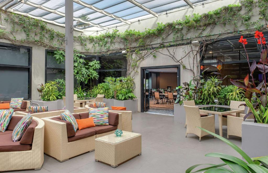 an outdoor patio with couches and tables and plants at Hilton Los Angeles-Universal City in Los Angeles