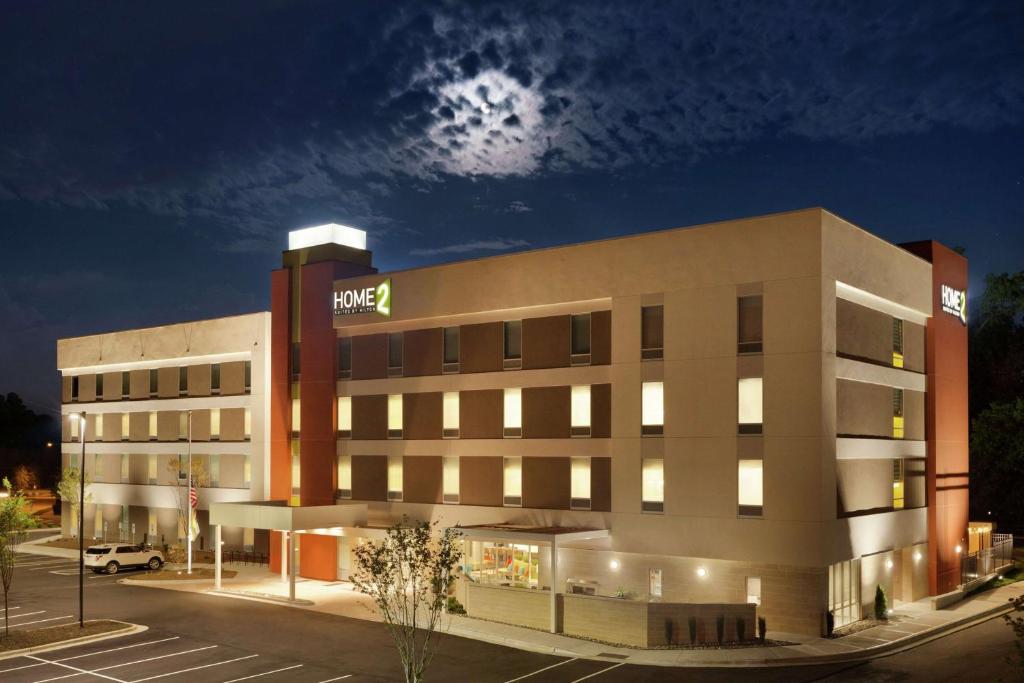 an office building with a hilton at night at Home2 Suites by Hilton Durham Chapel Hill in Durham