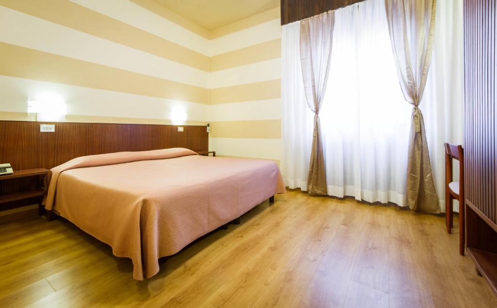 Postel nebo postele na pokoji v ubytování Hotel Reale