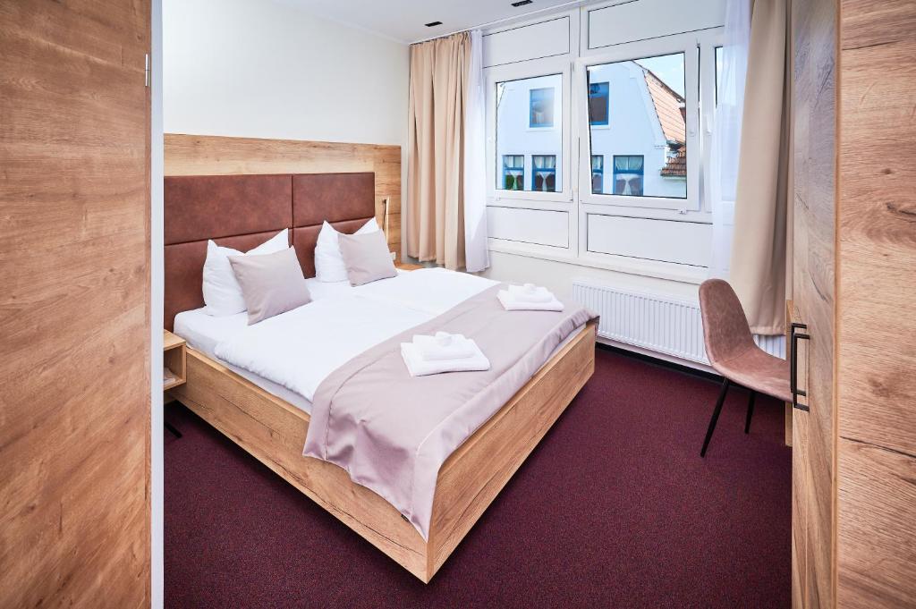 Hotel 53° Nord tesisinde bir odada yatak veya yataklar