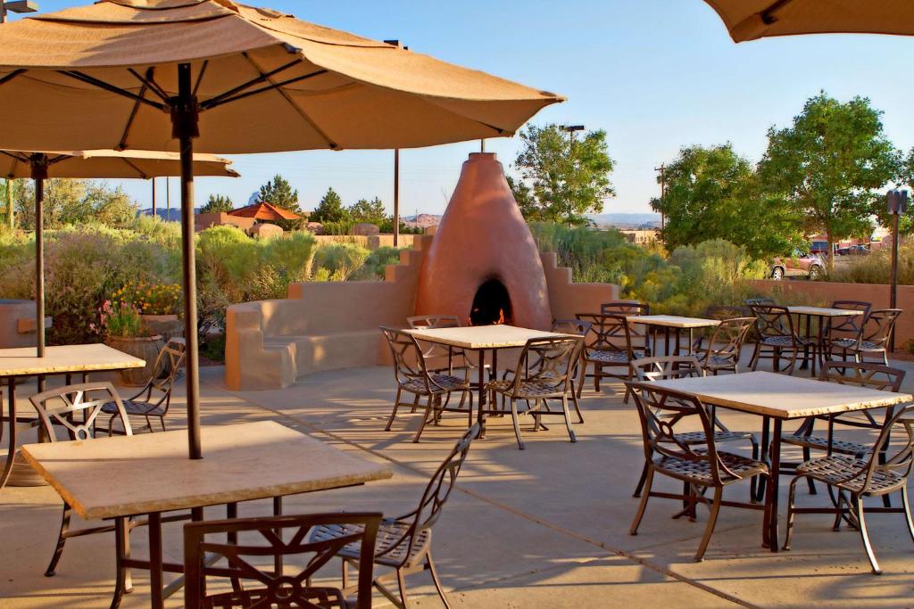 an outdoor patio with tables and chairs and an oven at Hampton Inn Kayenta Monument Valley in Kayenta