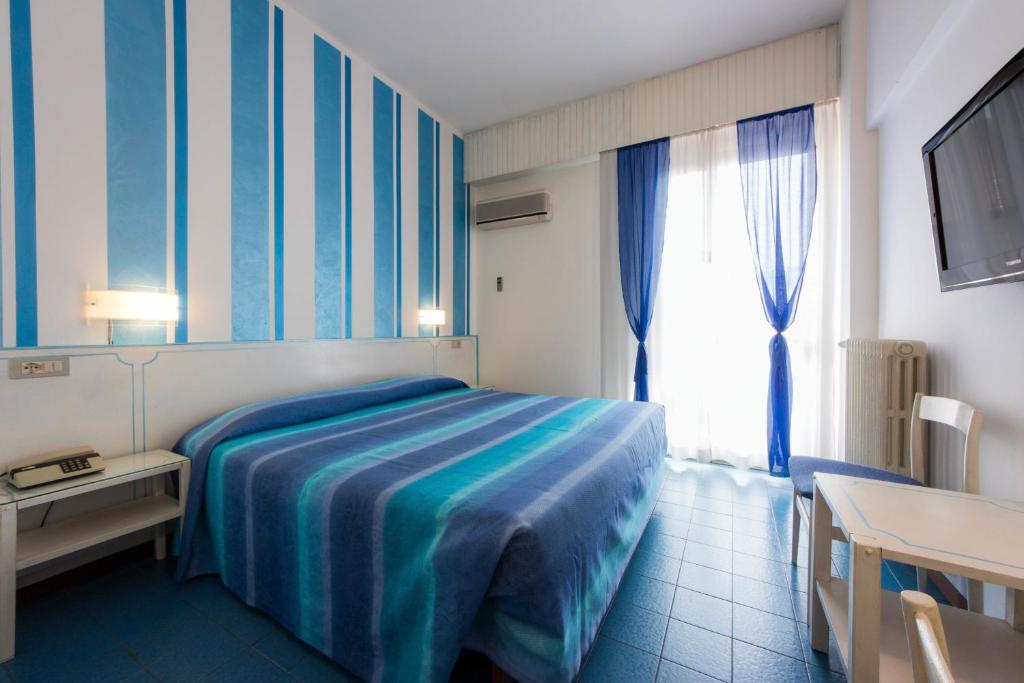 a hotel room with a bed and a window at Hotel Reale in Montecatini Terme