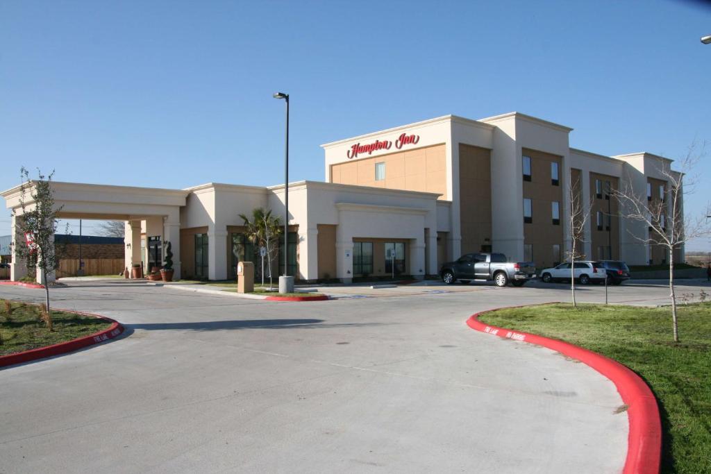 a building with a parking lot in front of it at Hampton Inn La Grange in La Grange