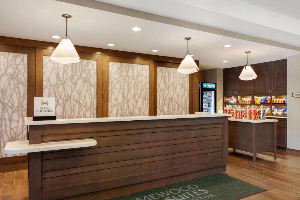a bar in a restaurant with two pendant lights at Homewood Suites by Hilton Gateway Hills Nashua in Nashua