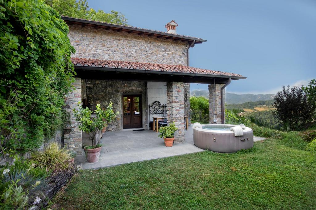 Cette petite maison en pierre dispose d'une baignoire dans la cour. dans l'établissement Birillina Guest House di Laura Reni, à Poggio