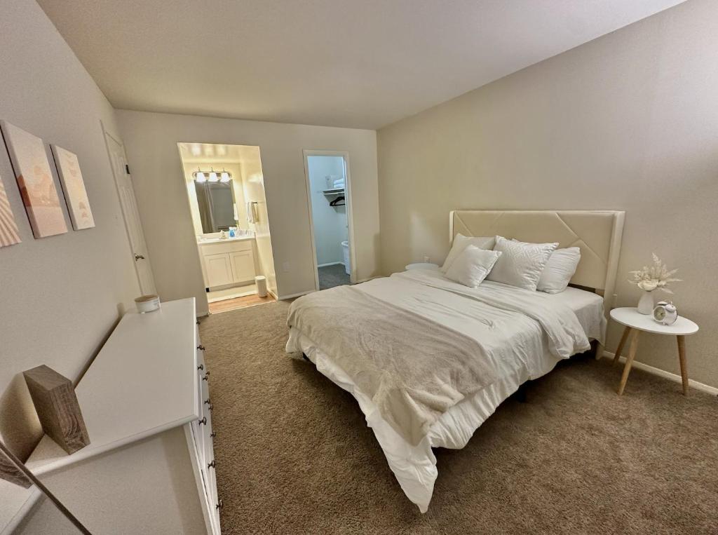 a bedroom with a large white bed and a table at Cozy Apartment in Frederick in Frederick