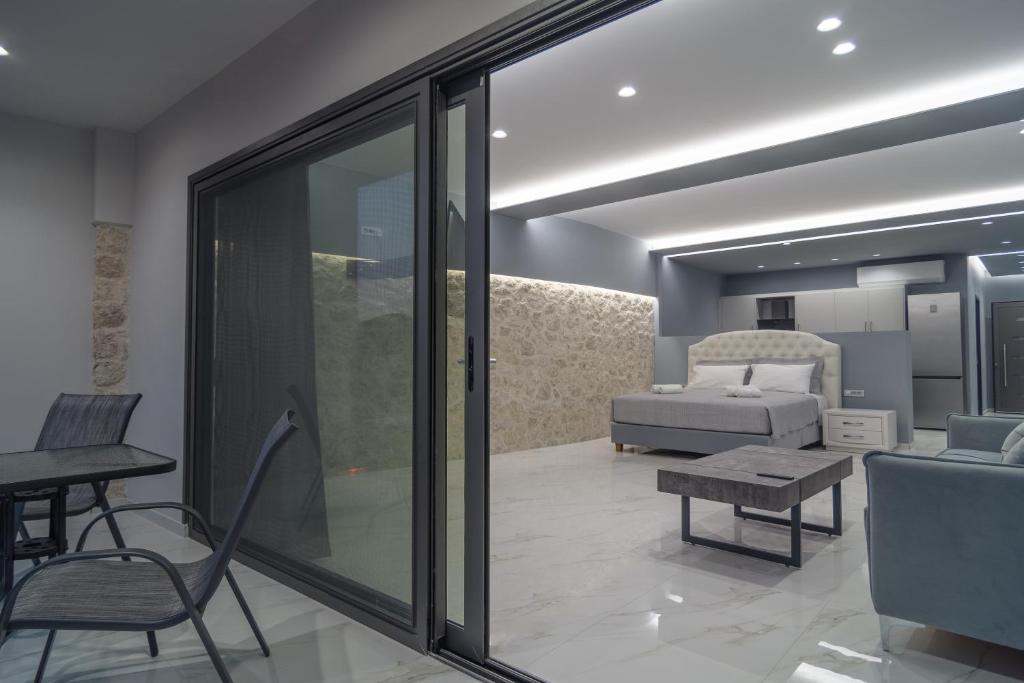 a living room with a couch and a bed at Irida Studios and Suite in Paleokastritsa