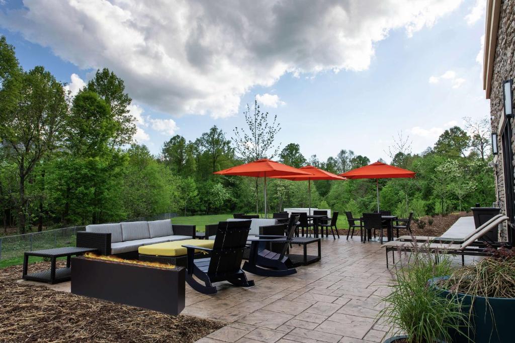 a patio with tables and chairs and umbrellas at Hampton Inn Black Mountain in Black Mountain