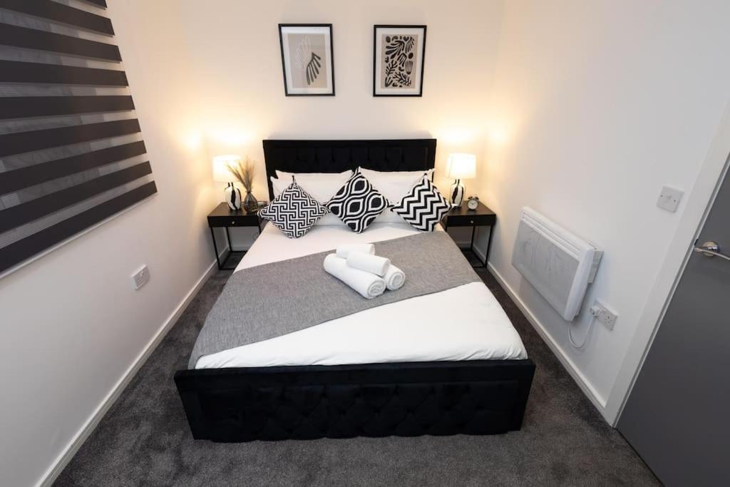 a bedroom with a large bed and a tv at Comfort on Market St l 1BR 1BA l Gem in Watford in Watford
