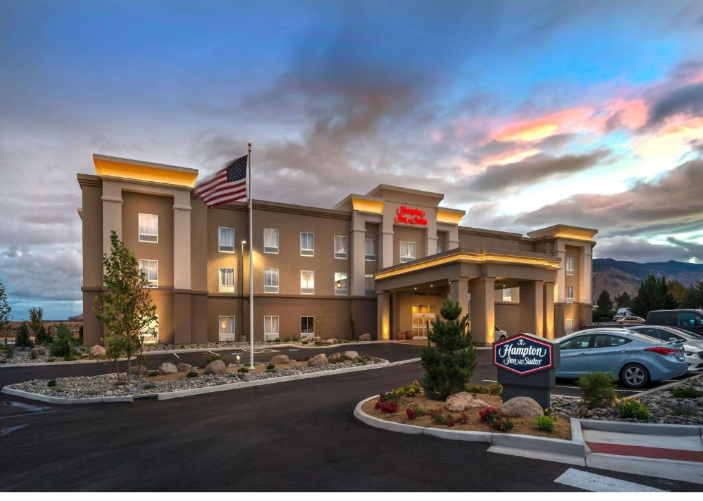 a hotel with an american flag in a parking lot at Hampton Inn & Suites - Reno West, NV in Reno