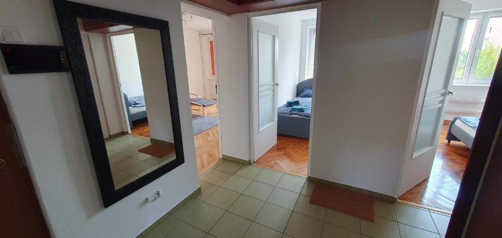 a hallway with a mirror and a living room at Czarna Woda in Czarna Woda