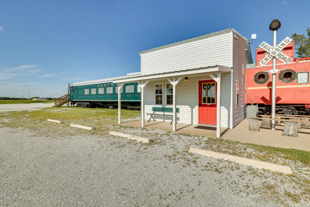 a train station with a train engine and a train station at Charming Converted Railcar Studio in Joplin! in Joplin