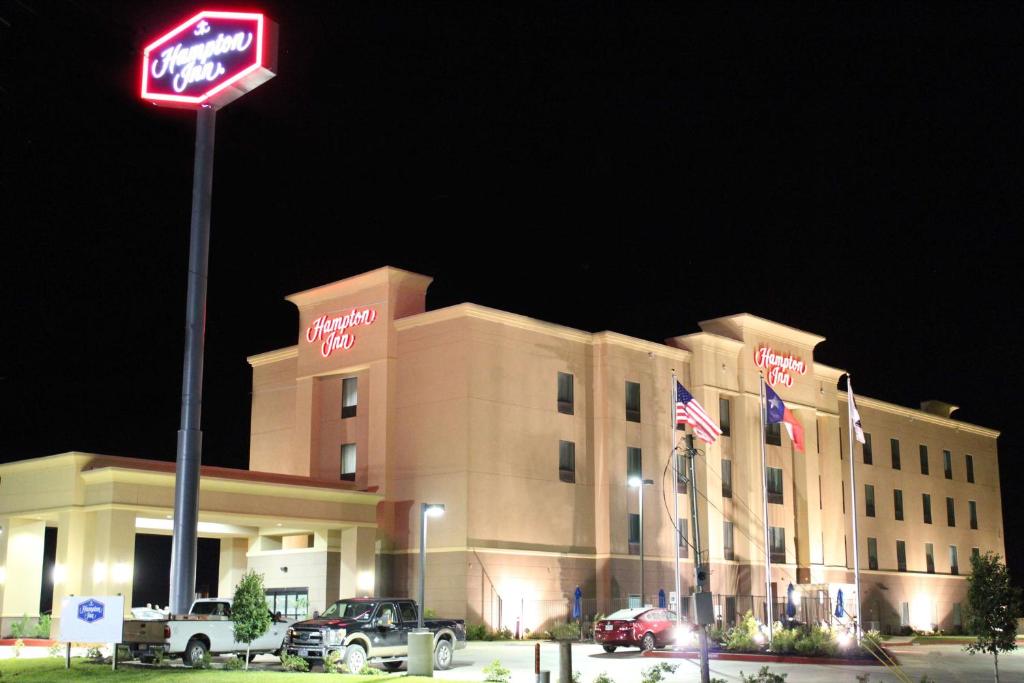 a hotel with a sign in front of it at Hampton Inn Cotulla in Cotulla