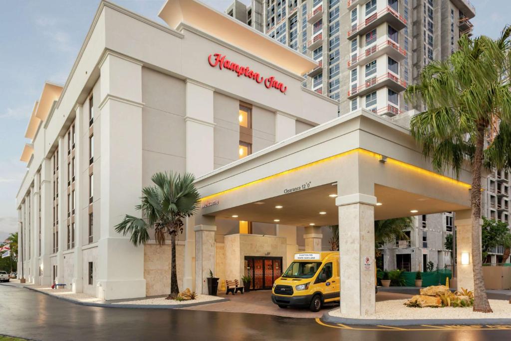 a yellow van parked in front of a building at Hampton Inn Miami/Dadeland in South Miami