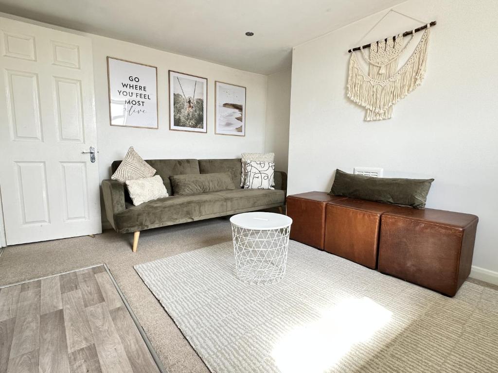 a living room with a couch and a table at Central City Beach Pad in Brighton & Hove