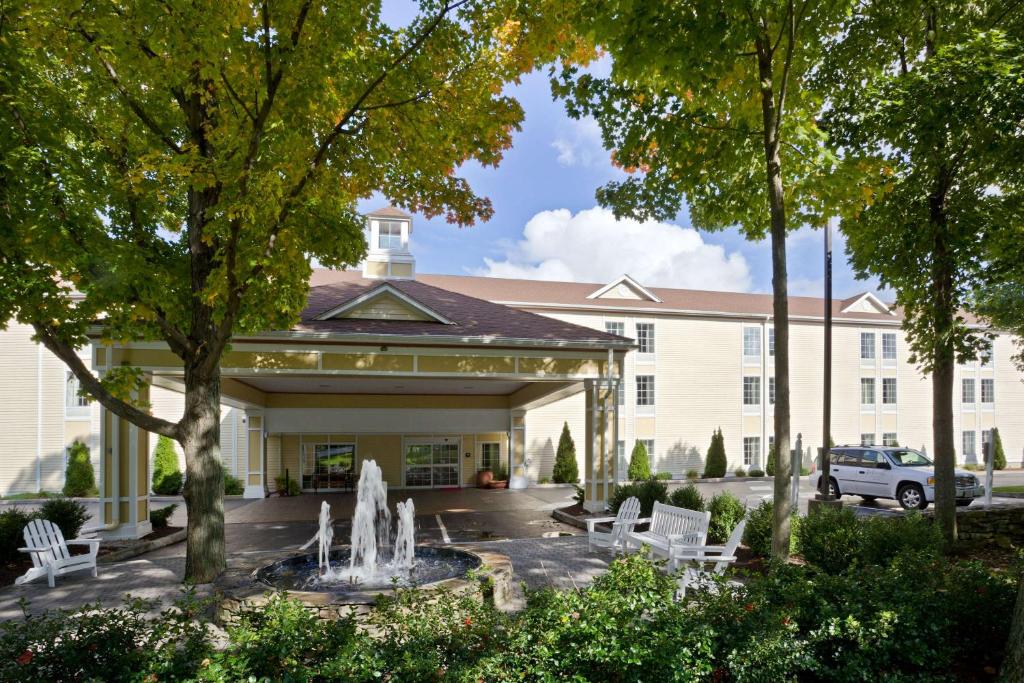 a building with a fountain in front of it at Hampton Inn Sturbridge in Sturbridge