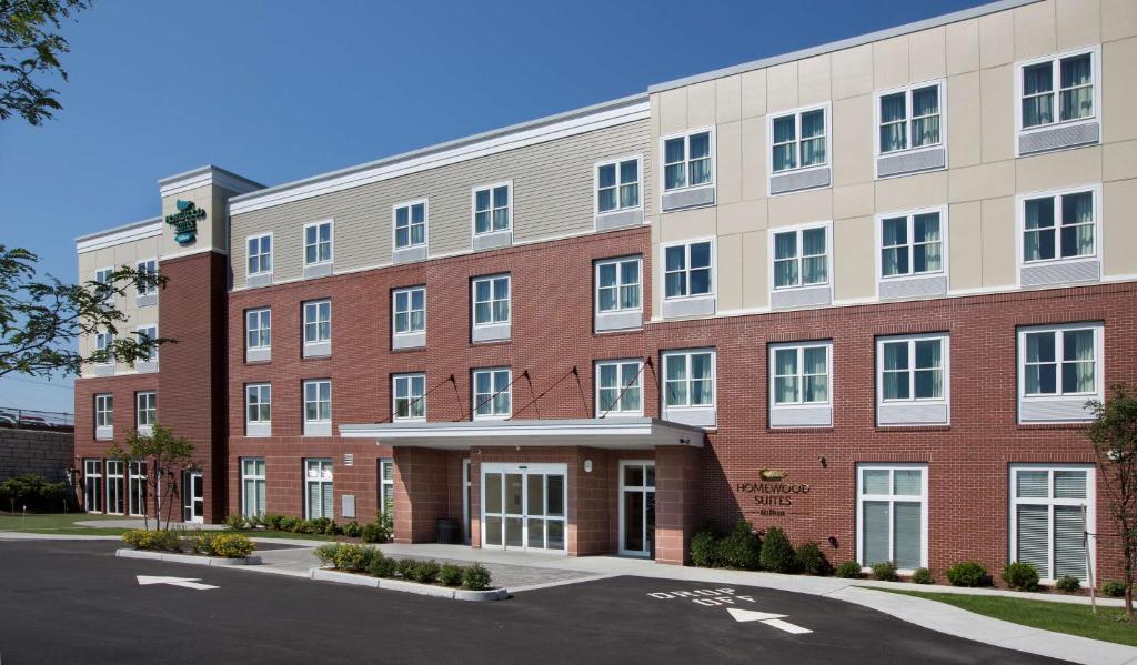 an exterior view of a red brick building at Homewood Suites by Hilton Newport-Middletown in Middletown