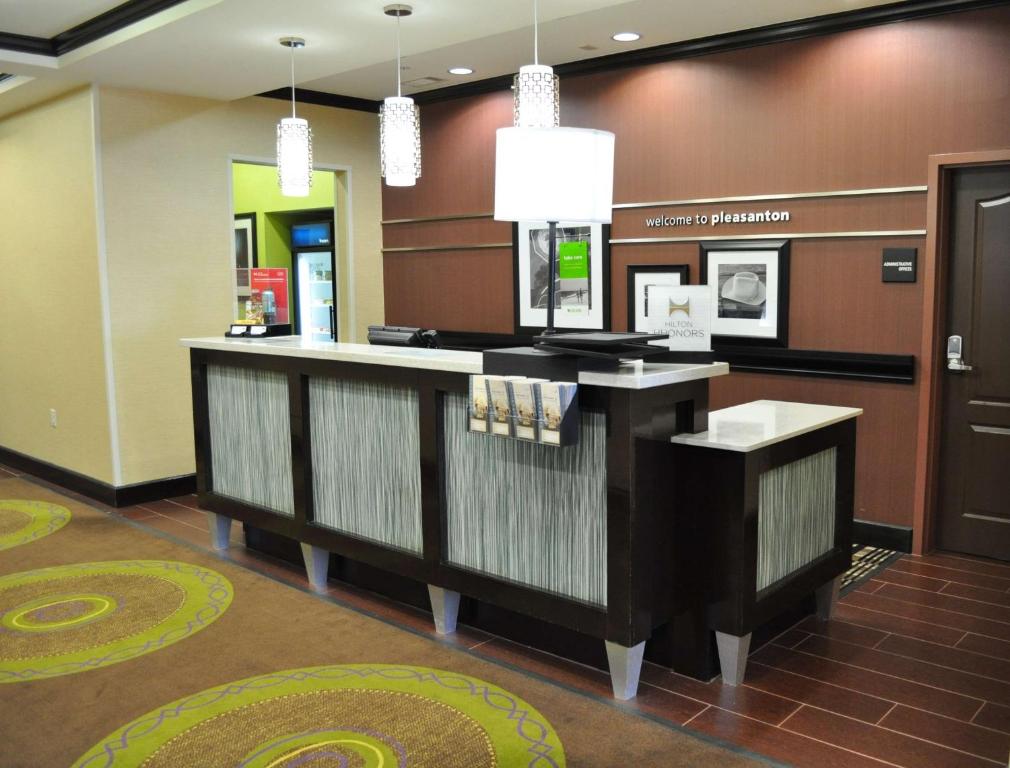a lobby with a reception counter in a hospital at Hampton Inn Pleasanton in Pleasanton
